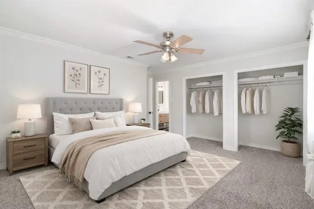 a bedroom with a large bed and a chandelier