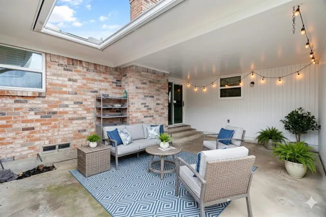 a living room with furniture and flowers