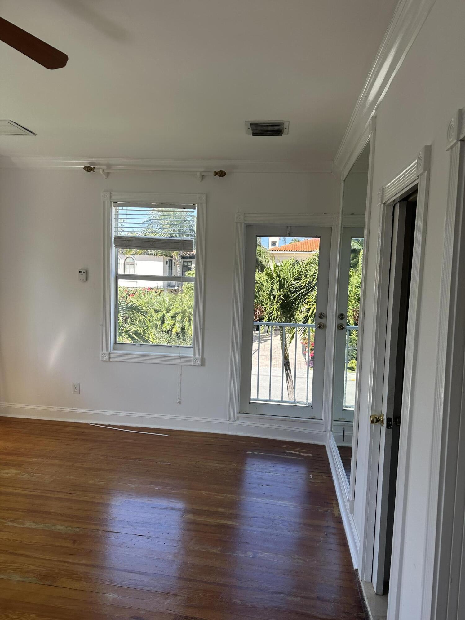 258 Seminole Avenue, Unit 4 Palm Beach, FL 33480 - Photo 4 of 10 an empty room with wooden floor and windows