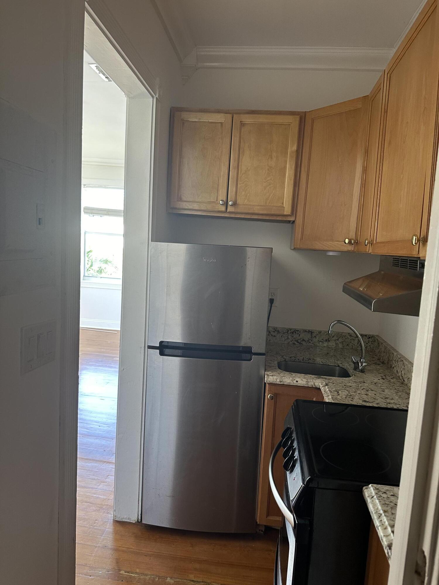 258 Seminole Avenue, Unit 4 Palm Beach, FL 33480 - Photo 6 of 10 a white refrigerator freezer sitting in a kitchen