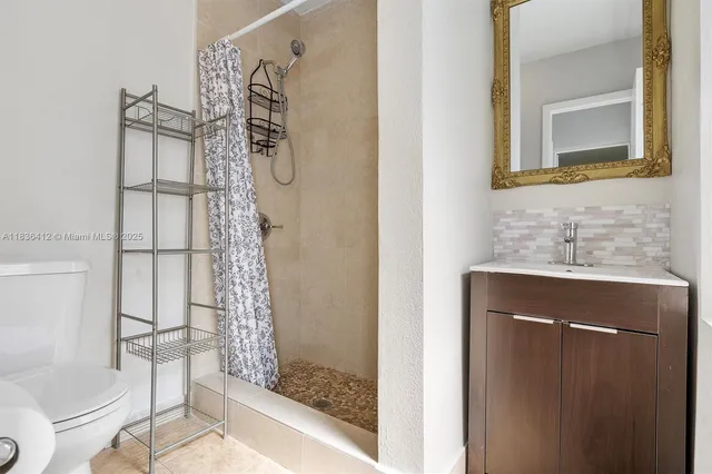 a bathroom with a sink toilet and shower