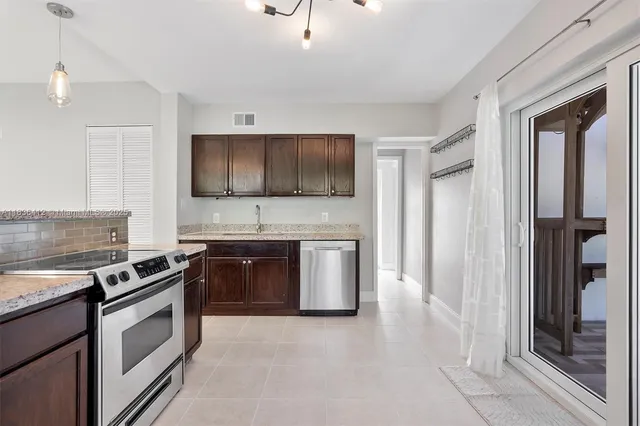 a kitchen with stainless steel appliances granite countertop a stove and a sink