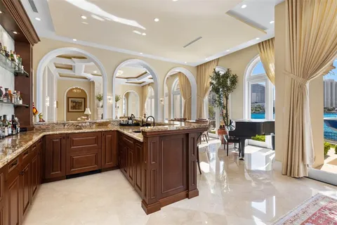 a kitchen with stainless steel appliances a dining table chairs and chandelier