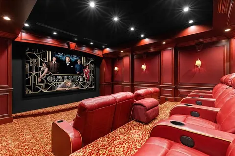 a spacious bedroom with a bed and a chandelier