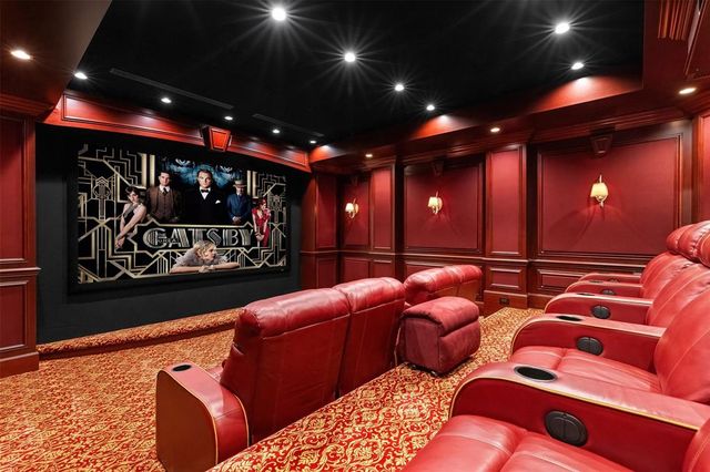 a spacious bedroom with a bed and a chandelier