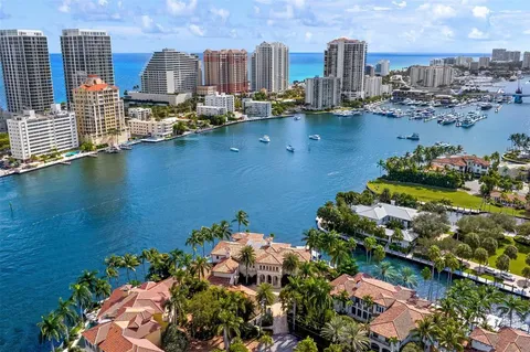 a living room with furniture a fireplace and a chandelier