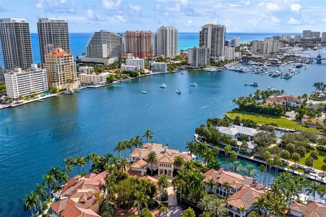 a living room with furniture a fireplace and a chandelier