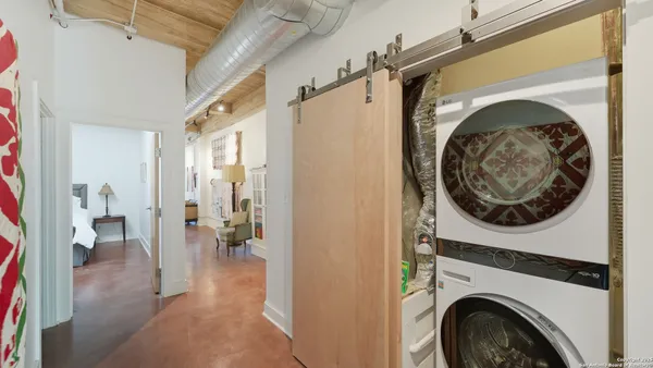a view of a hallway with washer and dryer
