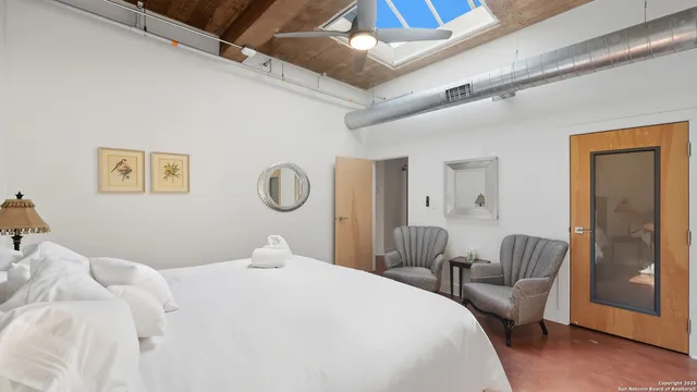 a bedroom with a bed and a chair