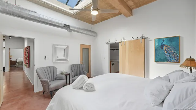 a bedroom with furniture and a large window