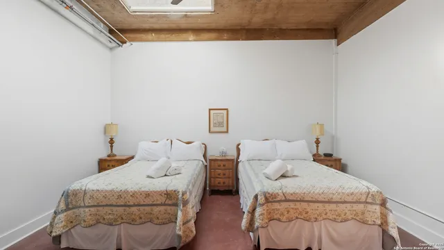 a bedroom with two beds and a window