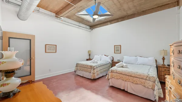 a bedroom with furniture and a mirror