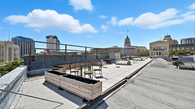 a view of a roof deck with furniture