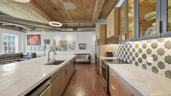 a kitchen with stainless steel appliances granite countertop a sink and stove