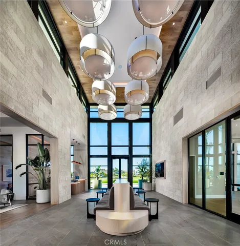 a living room with fireplace furniture and a large window