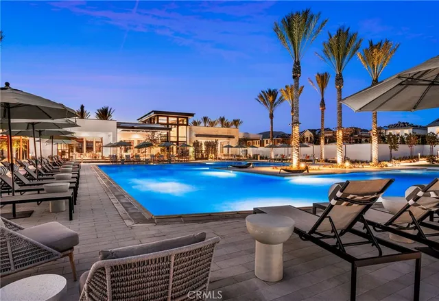 a roof deck with table and chairs under an umbrella