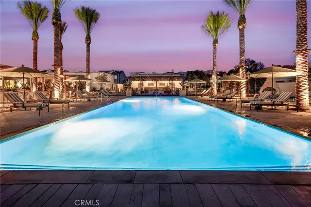 a view of a swimming pool with a table and chairs