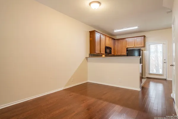 a view of a kitchen with a sink and a refrigerator