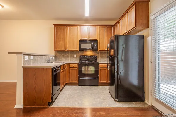 a kitchen with stainless steel appliances granite countertop a refrigerator stove and sink