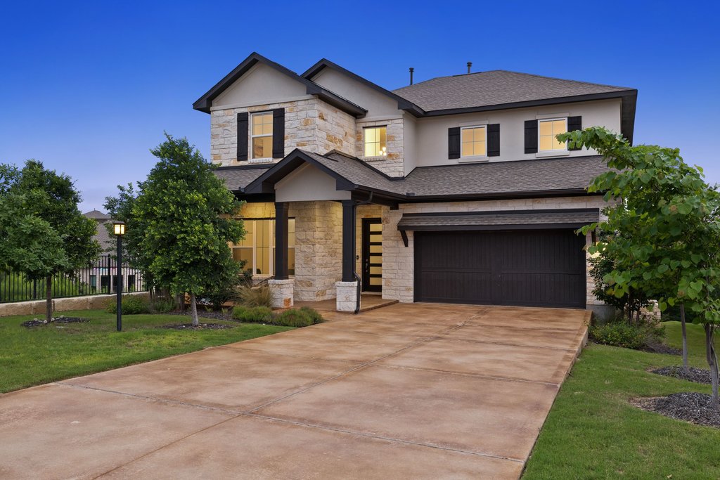 305 Avena Trail Austin, TX 78738 - Photo 1 of 40 a front view of a house with yard and green space