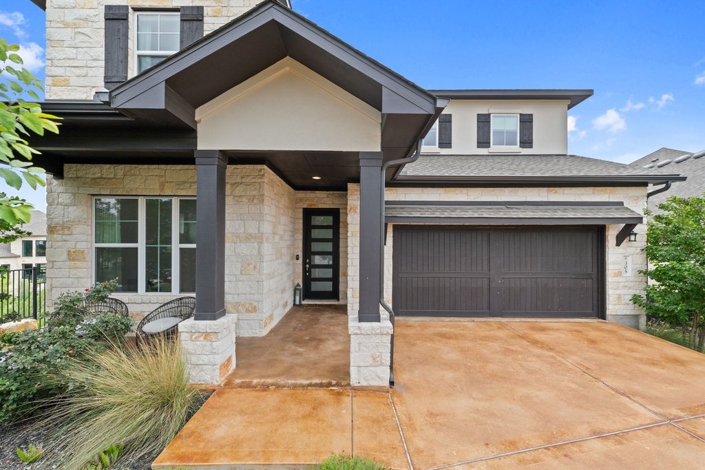 305 Avena Trail Austin, TX 78738 - Photo 16 of 40 a front view of a house with a yard and garage