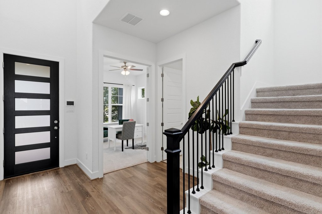 305 Avena Trail Austin, TX 78738 - Photo 18 of 40 Elegant entryway featuring wide lvp flooring, a modern 8' front door with frosted glass panels, and a light-filled layout that opens to a private office.