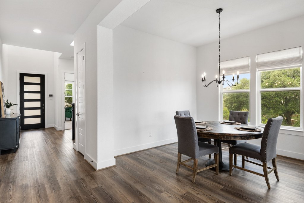 305 Avena Trail Austin, TX 78738 - Photo 19 of 40 a view of a dining room with furniture window and wooden floor