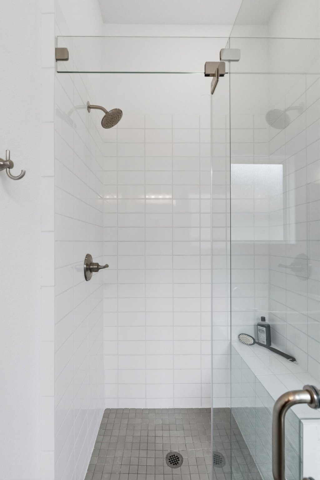 305 Avena Trail Austin, TX 78738 - Photo 28 of 40 Glass-enclosed shower featuring a rain shower head and a built-in bench for comfort.