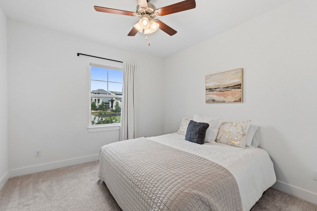 305 Avena Trail Austin, TX 78738 - Photo 31 of 40 a bedroom with a bed and a window