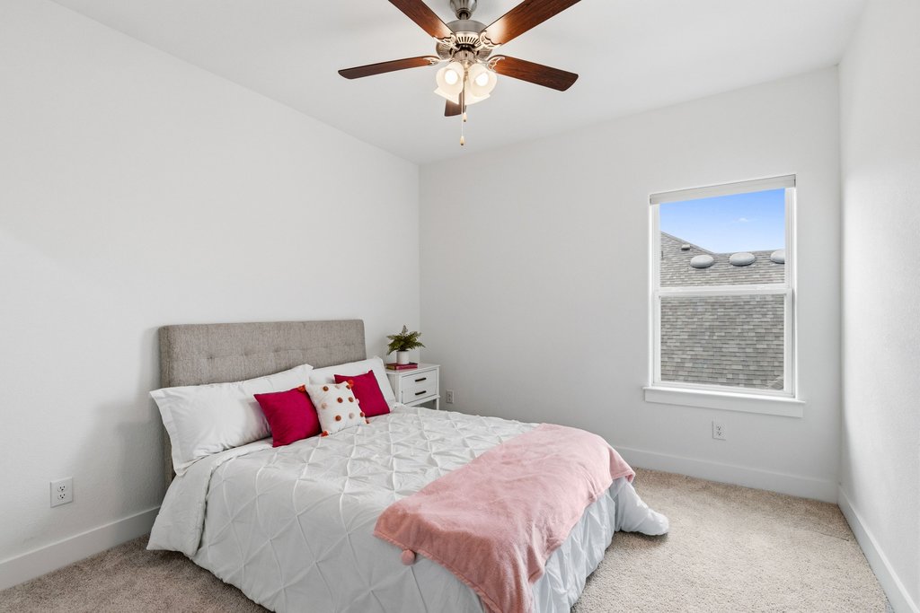 305 Avena Trail Austin, TX 78738 - Photo 33 of 40 a bedroom with a bed and a window