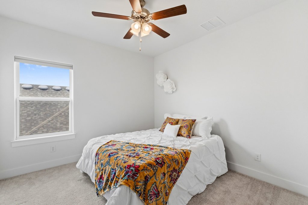 305 Avena Trail Austin, TX 78738 - Photo 35 of 40 a bedroom with a bed and window