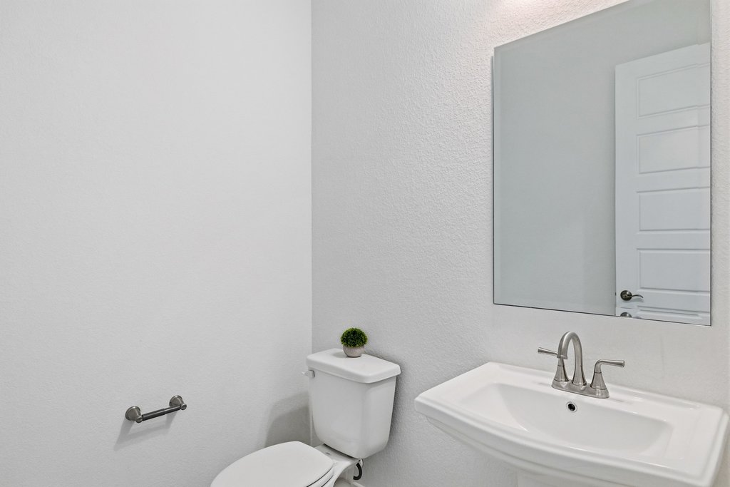 305 Avena Trail Austin, TX 78738 - Photo 36 of 40 a bathroom with a sink mirror and toilet