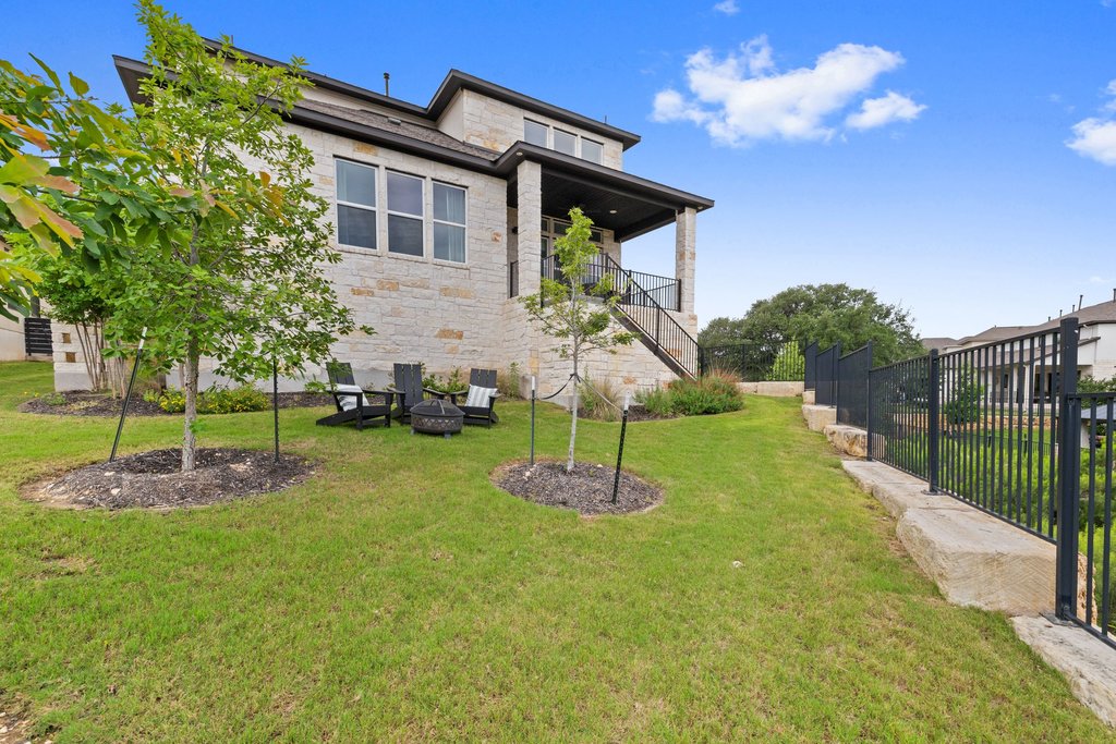 305 Avena Trail Austin, TX 78738 - Photo 38 of 40 Expansive backyard featuring a manicured lawn, a few trees, and a plenty of space for outdoor activities and backyard BBQ!