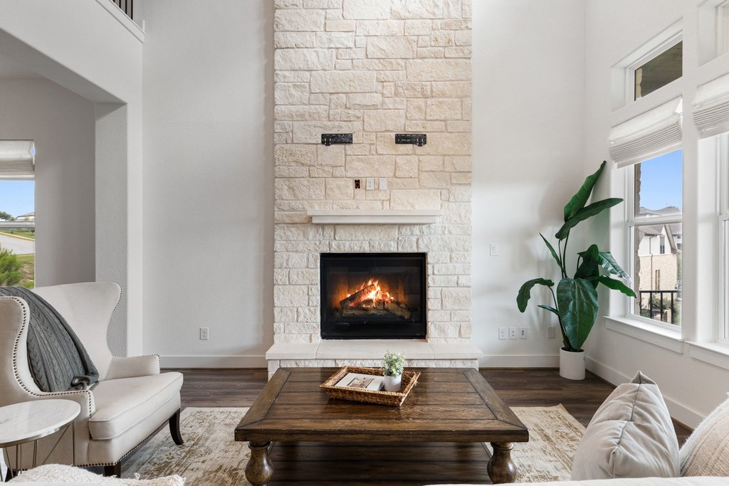 305 Avena Trail Austin, TX 78738 - Photo 4 of 40 a living room with furniture and a fireplace