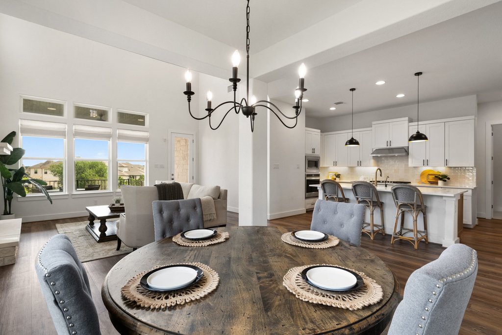 305 Avena Trail Austin, TX 78738 - Photo 5 of 40 a kitchen with stainless steel appliances granite countertop a table and chairs