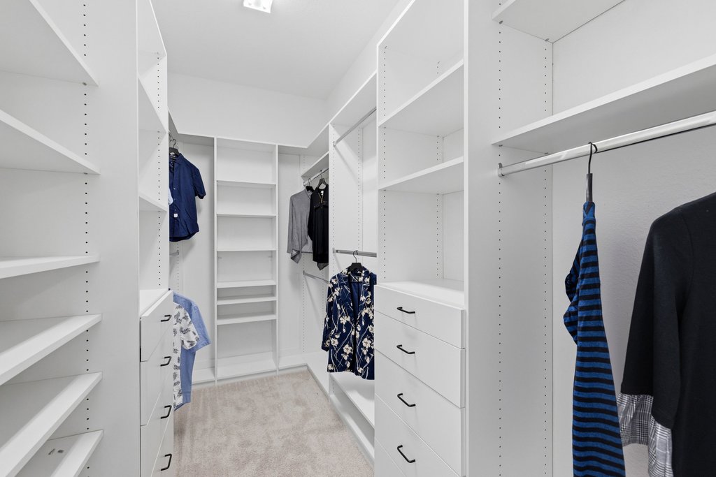 305 Avena Trail Austin, TX 78738 - Photo 9 of 40 a view of walk in closet with clothes and shoes