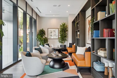 a living room with furniture a table and a large window