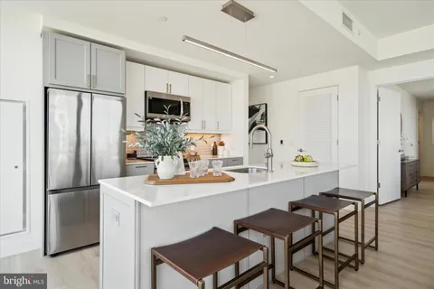 a kitchen with stainless steel appliances a refrigerator and a stove