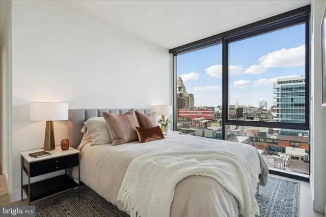 a bed sitting in a bedroom next to a large window