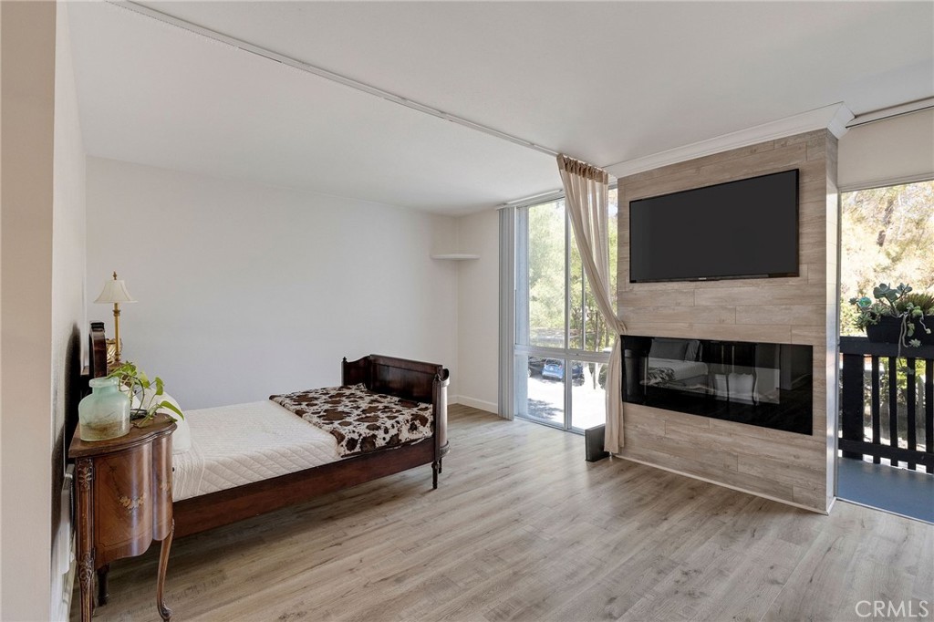 a living room with furniture fireplace and flat screen tv