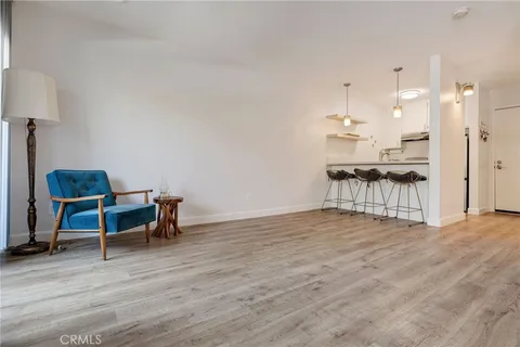 a view of a bedroom with wooden floor and a window