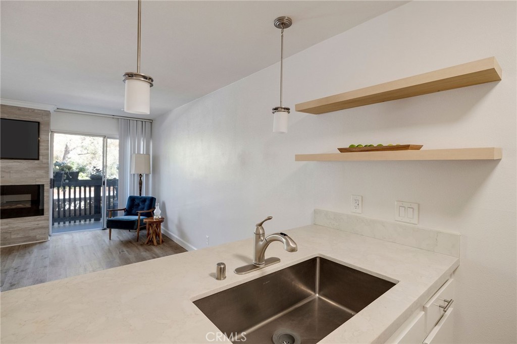 3604 West Estates Lane, Unit 114 Rolling Hills Estates, CA 90274 - Photo 15 of 59 a kitchen with a sink a counter and chairs