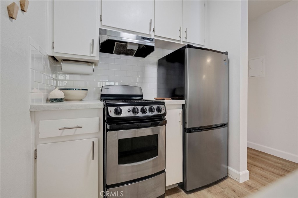 3604 West Estates Lane, Unit 114 Rolling Hills Estates, CA 90274 - Photo 17 of 59 a kitchen with stainless steel appliances white cabinets and a granite counter tops