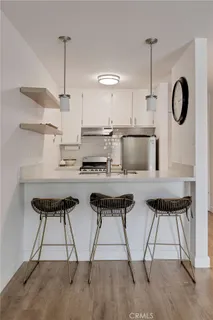 a kitchen with granite countertop a stove and a refrigerator