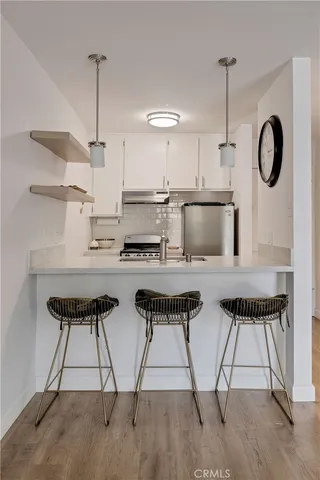a kitchen with granite countertop a stove and a refrigerator