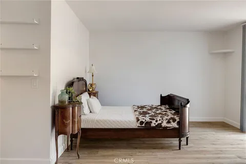 a bedroom with a bed and a lamp on table