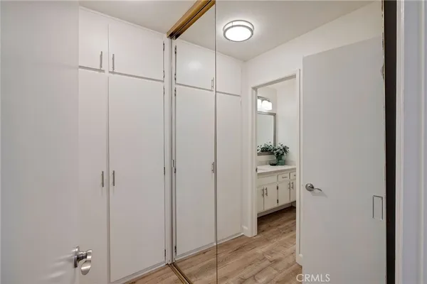 a view of a bathroom with a glass door and a wooden floor