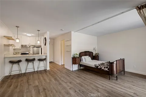 a living room with furniture and kitchen view
