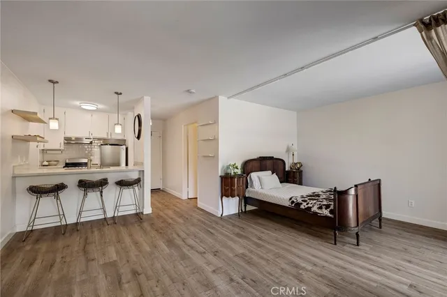 a living room with furniture and kitchen view