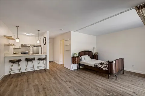 a living room with furniture and kitchen view